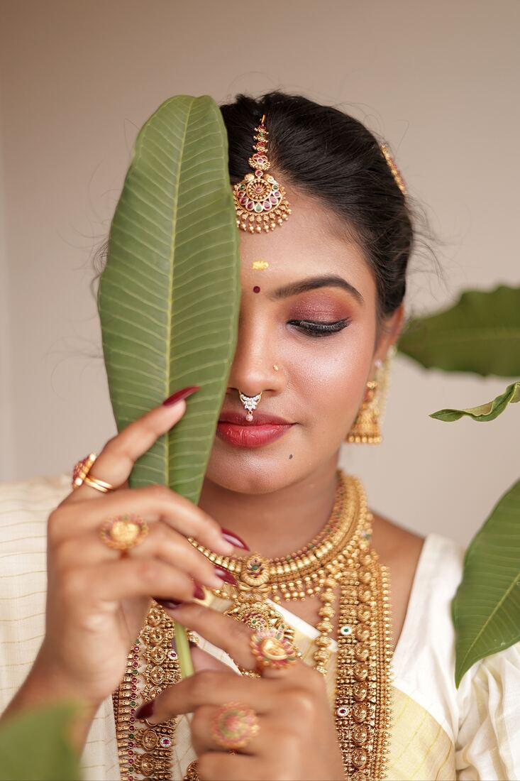 Bridal eye makeup close-up with green leaf, taught at Blossom Makeup Academy