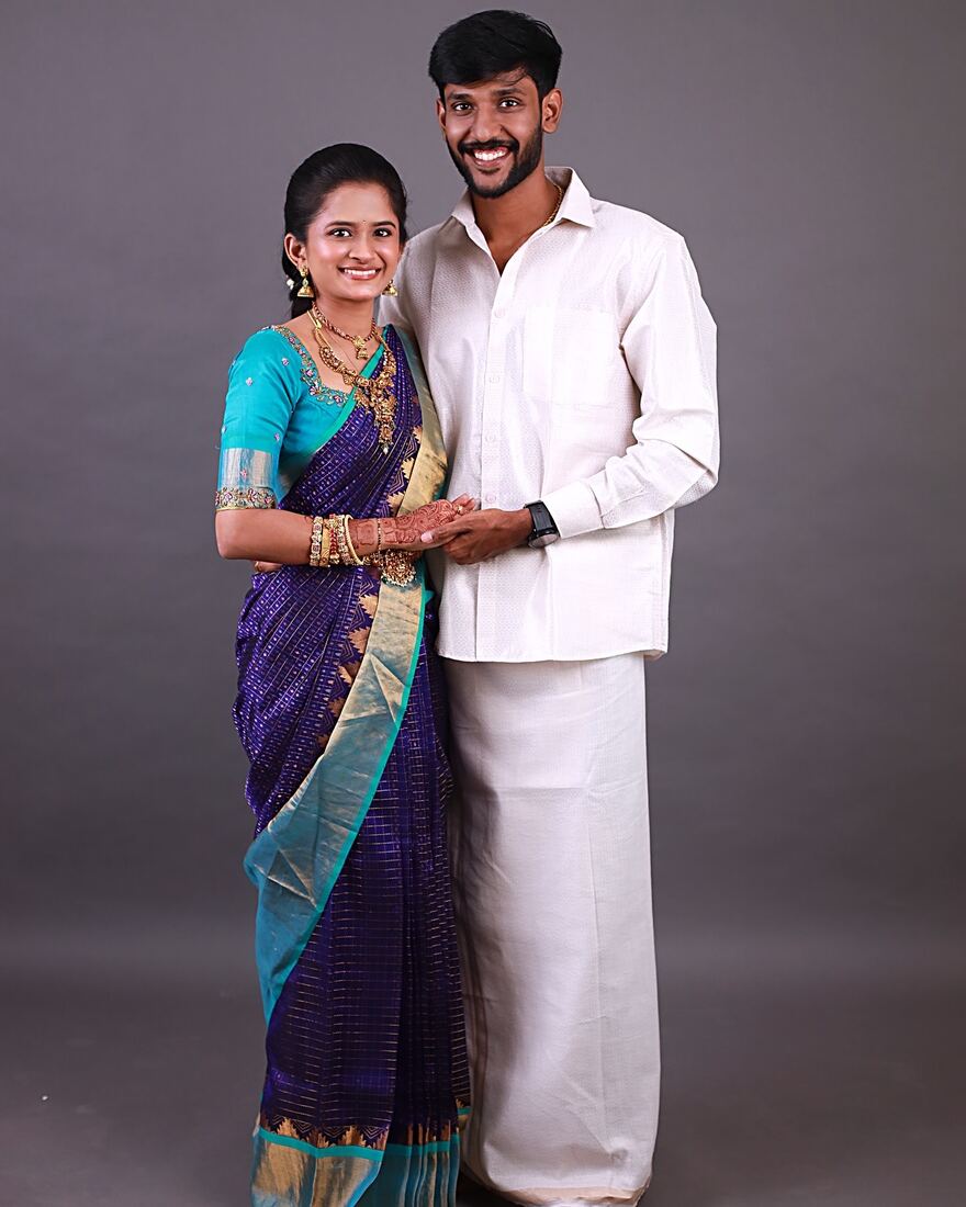 Groom with HD makeup standing with bride in blue silk saree, Madurai