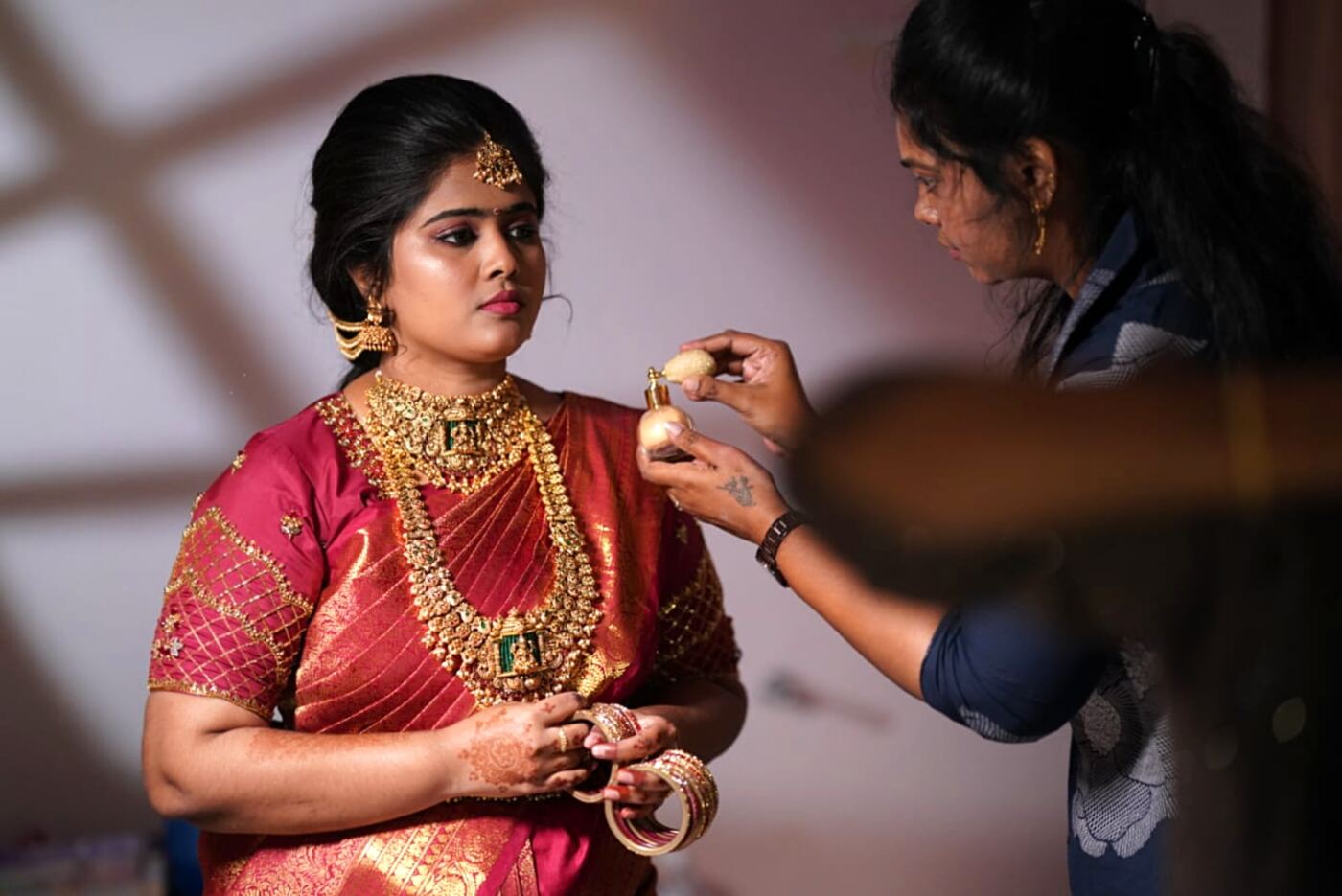 Blossom makeup artist doing HD bridal makeup for a bride in a Madurai makeup studio