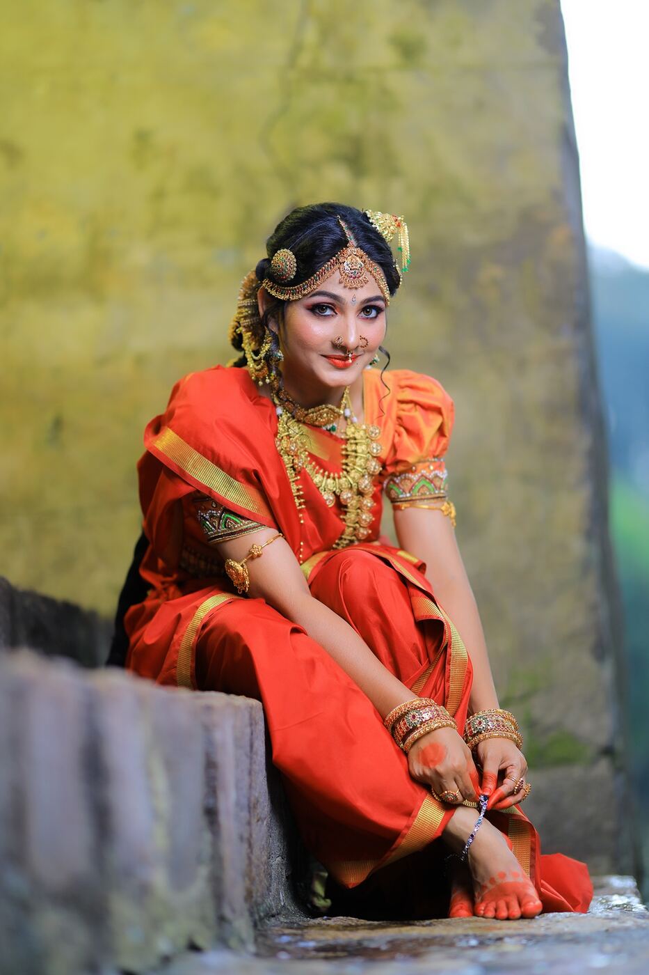Happy bride in orange silk saree after bridal makeup at Blossom, Madurai